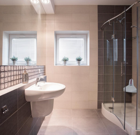 bathroom with sink, window and shower step