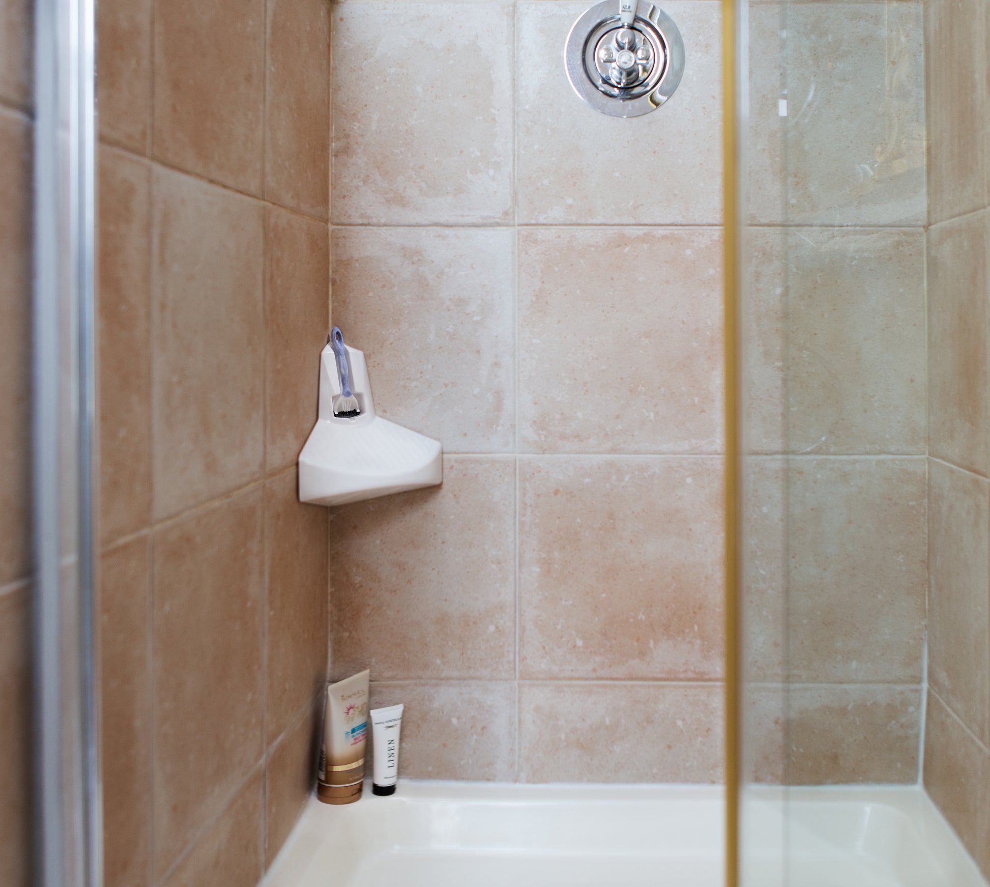 ElevEase shower step in a tan colored shower